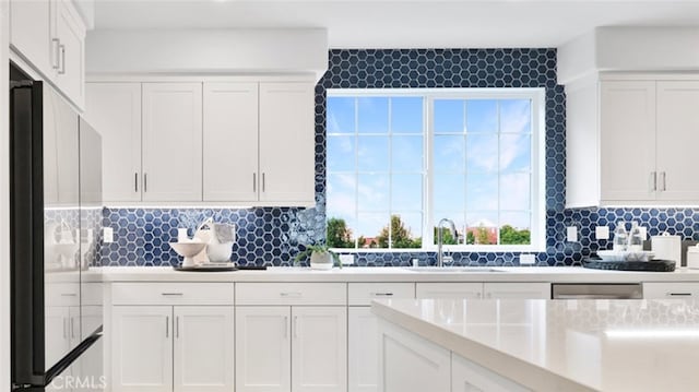 1060 N Anaheim Blvd, Anaheim, CA 92801 - kitchen featuring fridge, white cabinets, light countertops, and backsplash