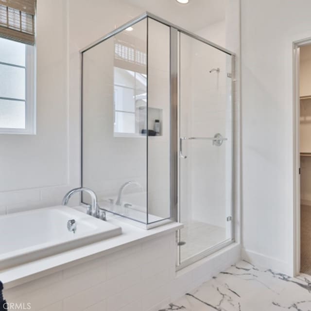 1060 N Anaheim Blvd, Anaheim, CA 92801 - full bathroom with a shower stall, a bath, a walk in closet, and marble look tiles