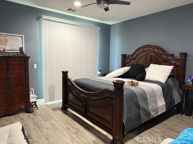 16001 Chase Rd Unit 111, Fontana, CA 92336 - bedroom featuring wood finished floors and a ceiling fan