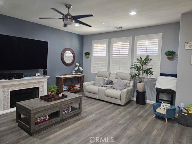 16001 Chase Rd Unit 111, Fontana, CA 92336 - living room featuring a ceiling fan, wood finished floors, a fireplace, and recessed lighting