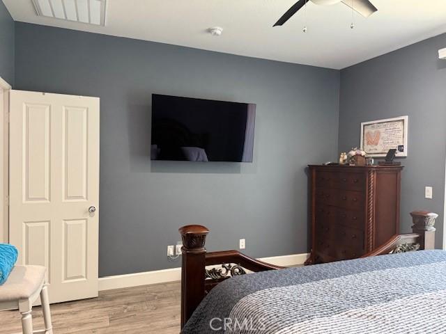16001 Chase Rd Unit 111, Fontana, CA 92336 - bedroom with wood finished floors and ceiling fan