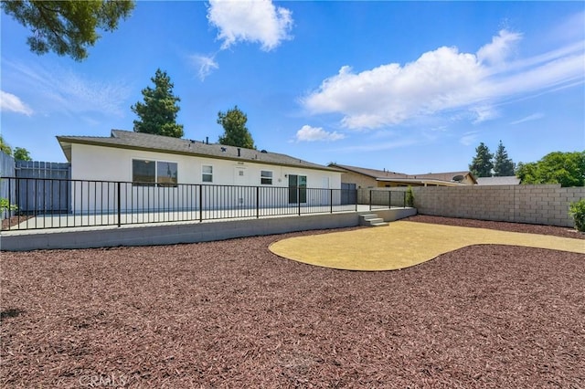 1717 Norval St, Pomona, CA 91766 - back of property featuring stucco siding, a fenced backyard, and a patio area