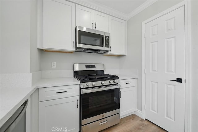 1717 Norval St, Pomona, CA 91766 - kitchen with stainless steel appliances, ornamental molding, light wood finished floors, white cabinetry, and light countertops