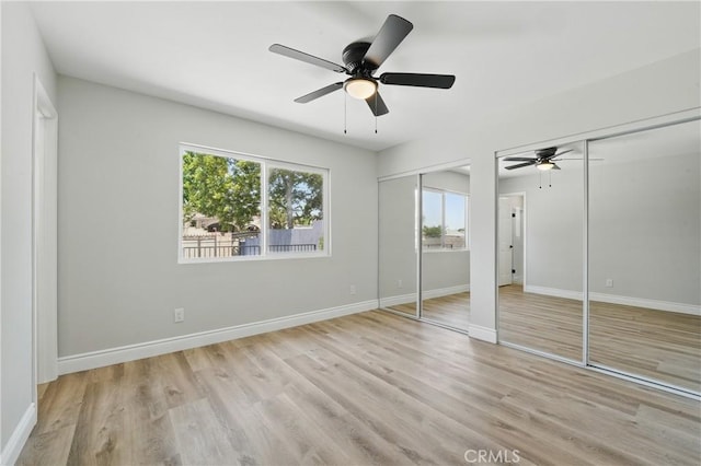 1717 Norval St, Pomona, CA 91766 - unfurnished bedroom with two closets, wood finished floors, and a ceiling fan