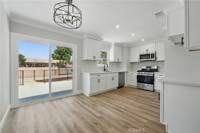 1717 Norval St, Pomona, CA 91766 - kitchen with appliances with stainless steel finishes, recessed lighting, light wood-type flooring, a chandelier, and ornamental molding