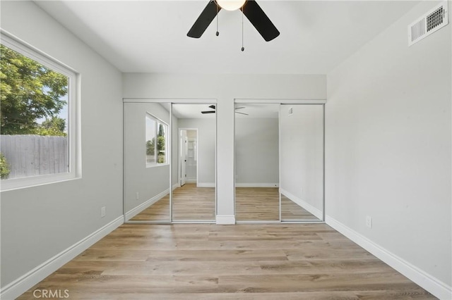 1717 Norval St, Pomona, CA 91766 - unfurnished bedroom with multiple windows, two closets, and wood finished floors