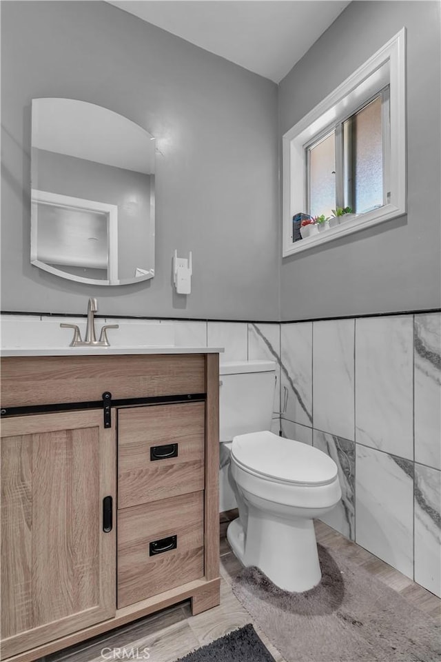 1109 Broadmoor Ave, La Puente, CA 91744 - half bath with vanity, tile walls, and a wainscoted wall