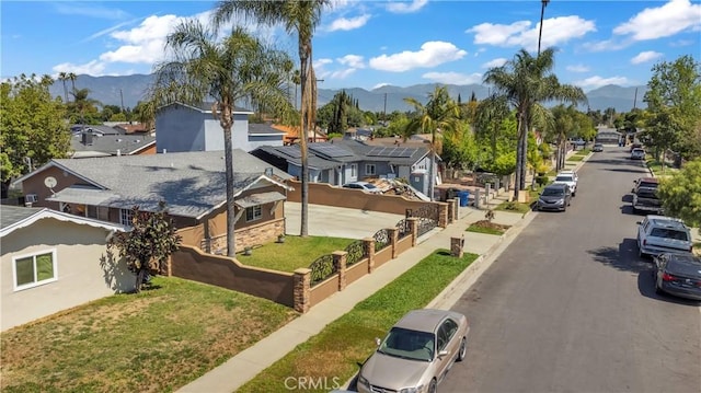 1109 Broadmoor Ave, La Puente, CA 91744 - view of asphalt road with a mountain view, a residential view, sidewalks, curbs, and street lights