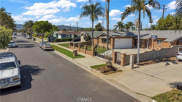 1109 Broadmoor Ave, La Puente, CA 91744 - view of asphalt street featuring curbs, a residential view, sidewalks, and a mountain view