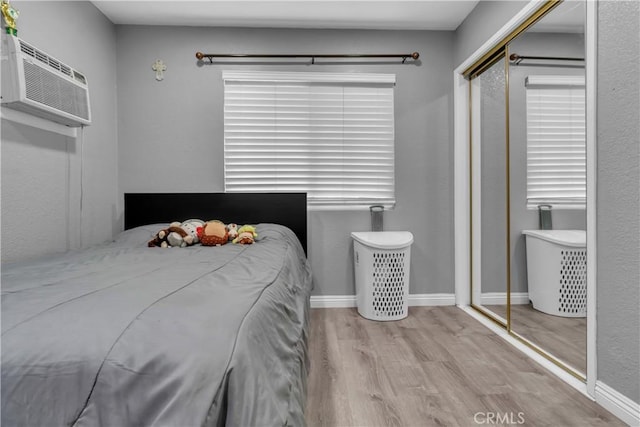 1109 Broadmoor Ave, La Puente, CA 91744 - bedroom featuring wood finished floors, a closet, and a wall mounted air conditioner