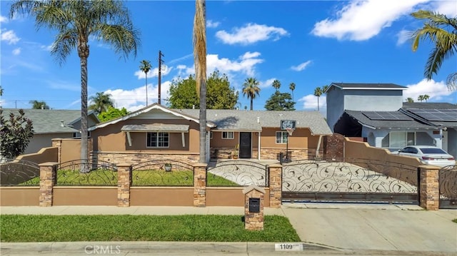 1109 Broadmoor Ave, La Puente, CA 91744 - view of front of home featuring stucco siding, stone siding, concrete driveway, and a fenced front yard