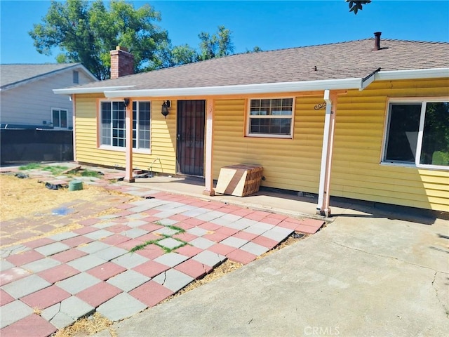 3424 Christie Ct, Sacramento, CA 95838 - back of house featuring a patio area, a chimney, and roof with shingles