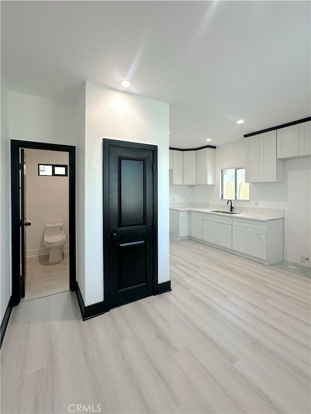 1295 E Whittier Ave, Hemet, CA 92543 - kitchen featuring light wood finished floors, white cabinets, light countertops, and recessed lighting