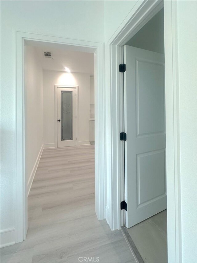 1295 E Whittier Ave, Hemet, CA 92543 - hallway featuring light wood finished floors and baseboards
