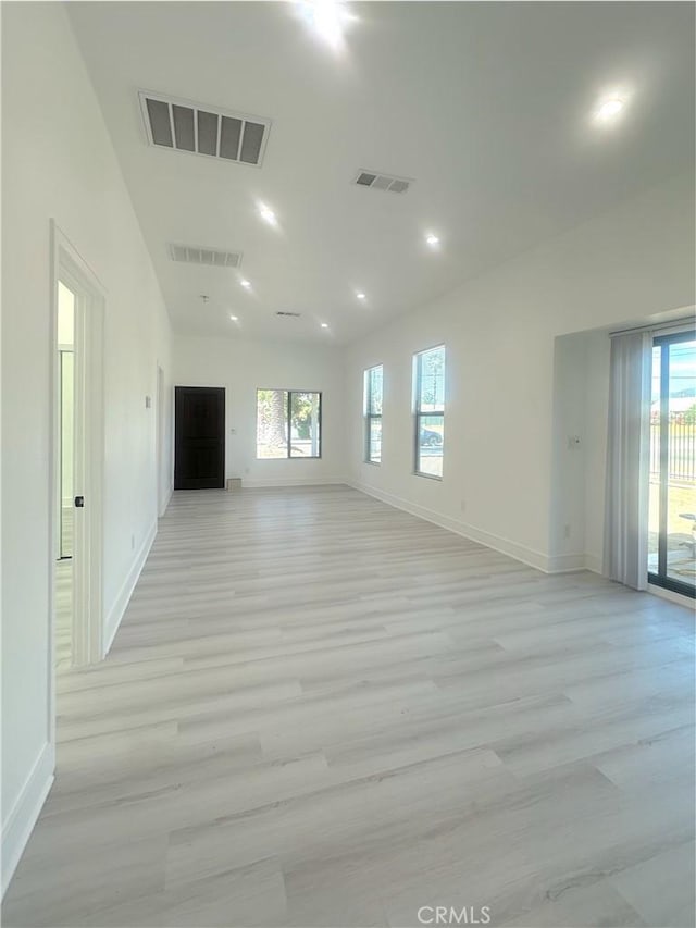 1295 E Whittier Ave, Hemet, CA 92543 - unfurnished living room with light wood-style flooring, recessed lighting, and vaulted ceiling