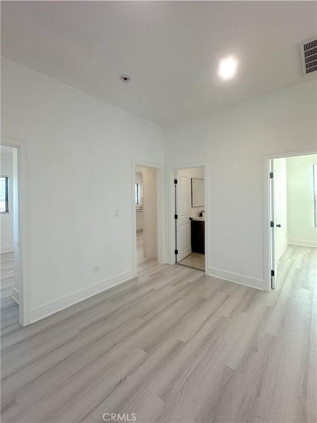 1295 E Whittier Ave, Hemet, CA 92543 - unfurnished bedroom featuring light wood-style flooring and connected bathroom