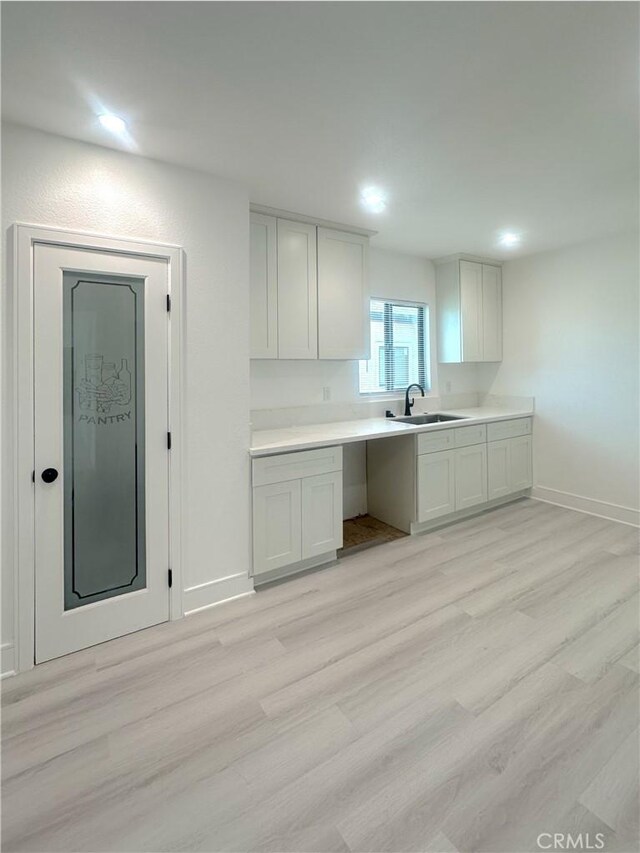 1295 E Whittier Ave, Hemet, CA 92543 - kitchen with light wood-type flooring and light countertops