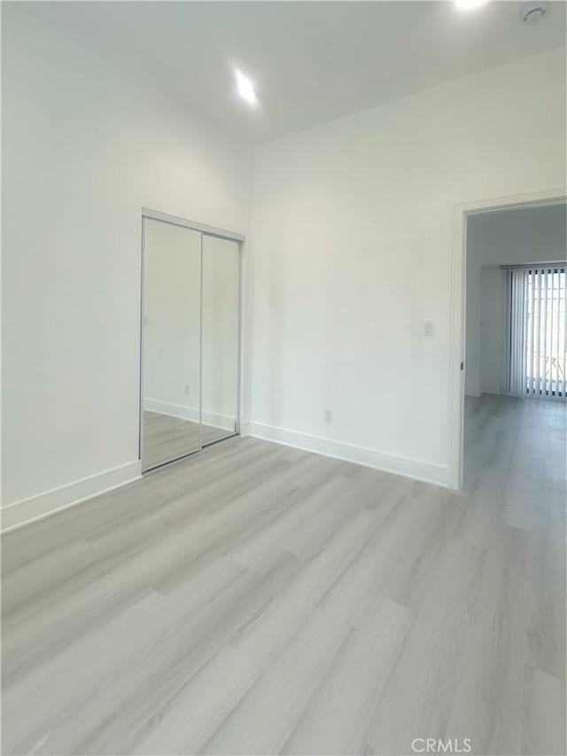 1295 E Whittier Ave, Hemet, CA 92543 - unfurnished bedroom with light wood finished floors and a closet