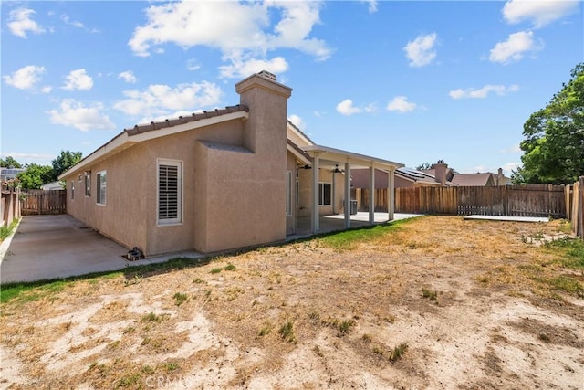 6327 W W Ave J5, Lancaster, CA 93536 - back of property with a patio area, a fenced backyard, ceiling fan, and stucco siding