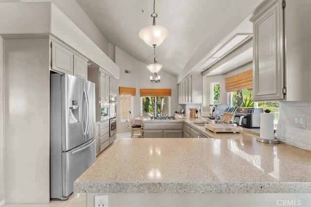 42 Paseo Alba, San Clemente, CA 92672 - kitchen with stainless steel fridge, lofted ceiling, a peninsula, backsplash, and hanging light fixtures