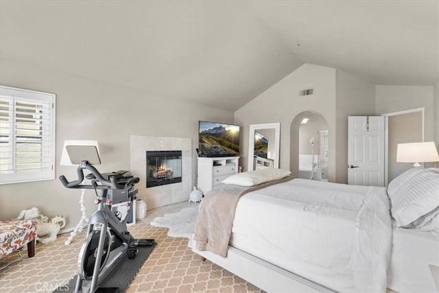 42 Paseo Alba, San Clemente, CA 92672 - carpeted bedroom with lofted ceiling, a tile fireplace, and arched walkways