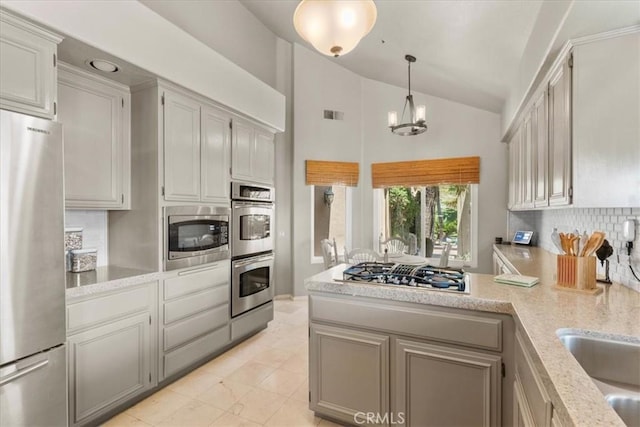 42 Paseo Alba, San Clemente, CA 92672 - kitchen featuring stainless steel appliances, a peninsula, tasteful backsplash, a chandelier, and hanging light fixtures