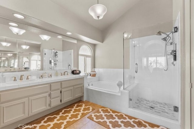 42 Paseo Alba, San Clemente, CA 92672 - bathroom featuring double vanity, a garden tub, vaulted ceiling, a shower stall, and tile patterned flooring