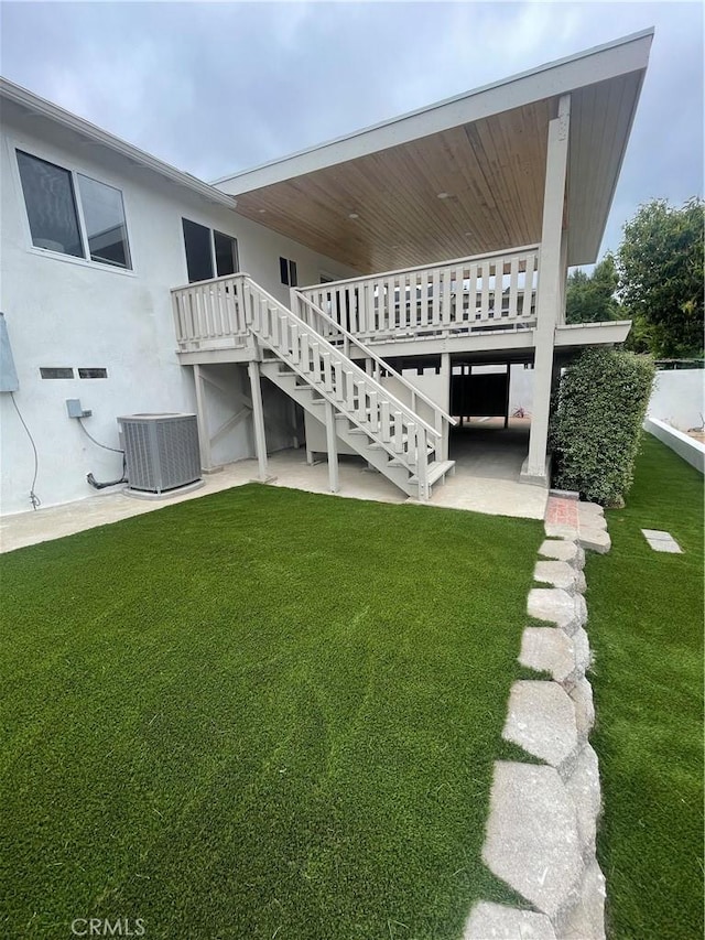 3273 Tilden Ave, Los Angeles, CA 90034 - view of grassy yard featuring stairway, a deck, and a patio