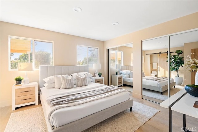 3273 Tilden Ave, Los Angeles, CA 90034 - bedroom featuring two closets, wood finished floors, recessed lighting, and a barn door