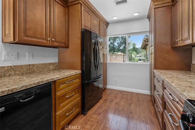 4346 Los Padres Dr, Fallbrook, CA 92028 - kitchen featuring black appliances, brown cabinetry, light wood finished floors, light countertops, and recessed lighting