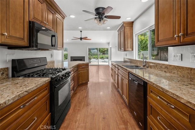 4346 Los Padres Dr, Fallbrook, CA 92028 - kitchen featuring black appliances, a ceiling fan, wood finished floors, recessed lighting, and light stone countertops