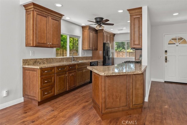 4346 Los Padres Dr, Fallbrook, CA 92028 - kitchen featuring freestanding refrigerator, a ceiling fan, a peninsula, dark wood-style flooring, and healthy amount of natural light