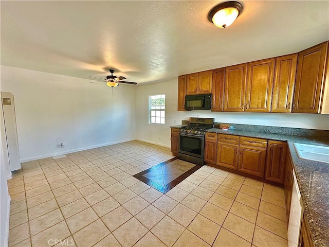 4727 Wilson St, Chino, CA 91710 - kitchen with black microwave, stainless steel gas range, light tile patterned flooring, dark countertops, and brown cabinetry