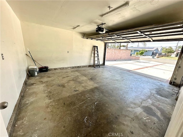 4727 Wilson St, Chino, CA 91710 - garage with a garage door opener and baseboards