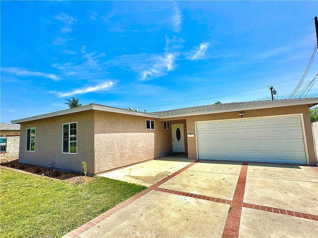4727 Wilson St, Chino, CA 91710 - ranch-style home featuring stucco siding, driveway, an attached garage, and a front lawn
