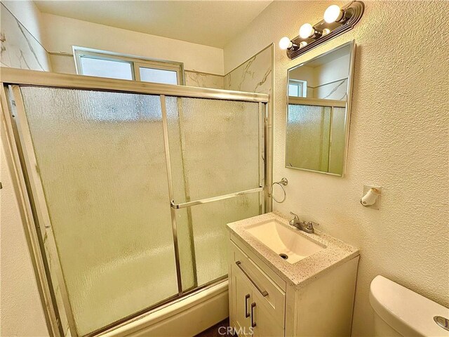 4727 Wilson St, Chino, CA 91710 - bathroom with vanity, a textured wall, and shower / bath combination with glass door