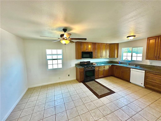 4727 Wilson St, Chino, CA 91710 - kitchen with black appliances, a textured ceiling, brown cabinets, light tile patterned flooring, and dark countertops