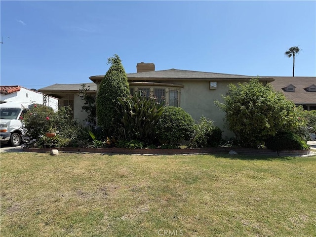 2126 W 77th St, Los Angeles, CA 90047 - view of front of home with a front lawn, stucco siding, and a chimney