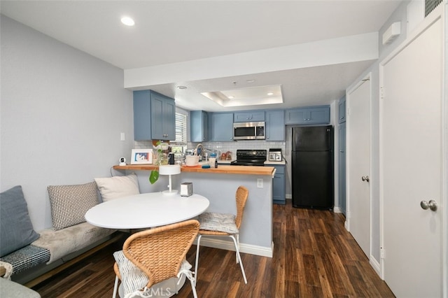 8718 E Indian Hills Rd Unit J, Orange, CA 92869 - kitchen featuring freestanding refrigerator, stainless steel microwave, blue cabinetry, a peninsula, and recessed lighting