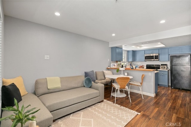 8718 E Indian Hills Rd Unit J, Orange, CA 92869 - living room featuring dark wood finished floors, recessed lighting, and a raised ceiling