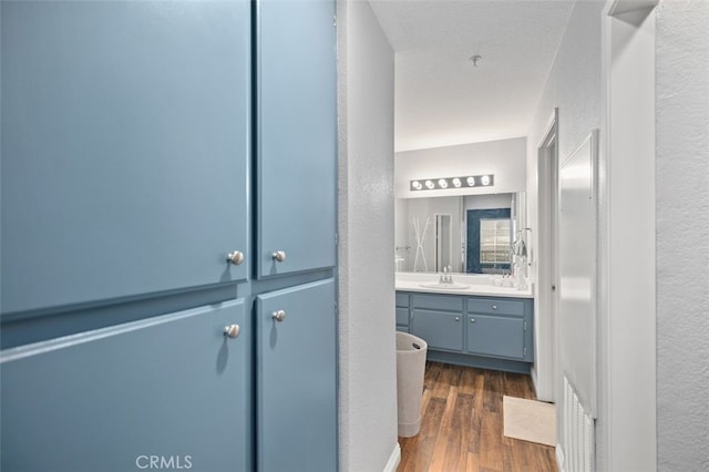 8718 E Indian Hills Rd Unit J, Orange, CA 92869 - bathroom with vanity, a textured wall, and wood finished floors