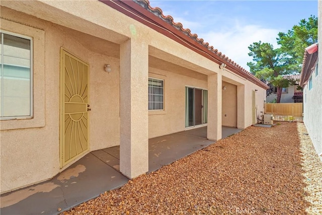 19192 Garcelon Ct, Apple Valley, CA 92308 - doorway to property with stucco siding, a patio, and a tile roof