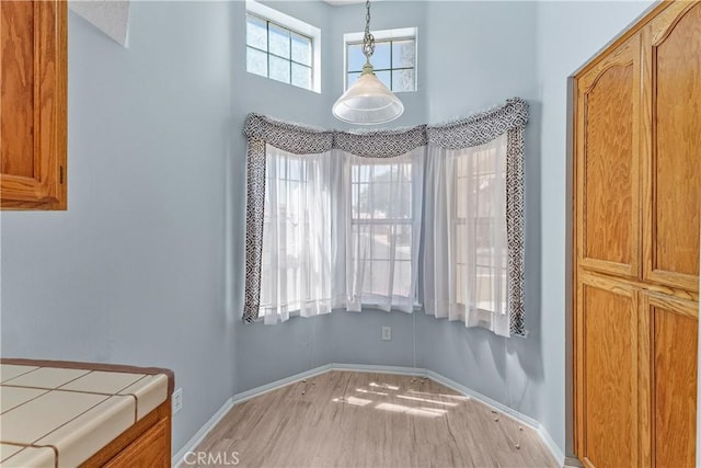 19192 Garcelon Ct, Apple Valley, CA 92308 - unfurnished dining area featuring light wood-style floors and a towering ceiling