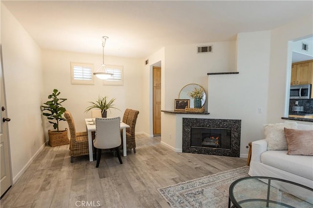 1530 Cyrus Ln, Placentia, CA 92870 - dining area featuring light wood-style flooring and a fireplace