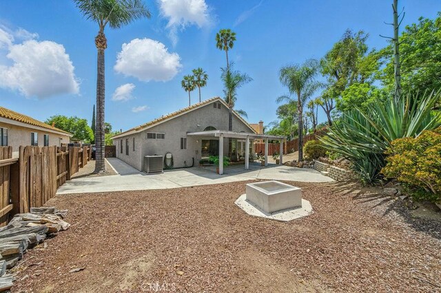 24322 Via Las Junitas, Murrieta, CA 92562 - back of house with stucco siding, a patio area, and a fenced backyard