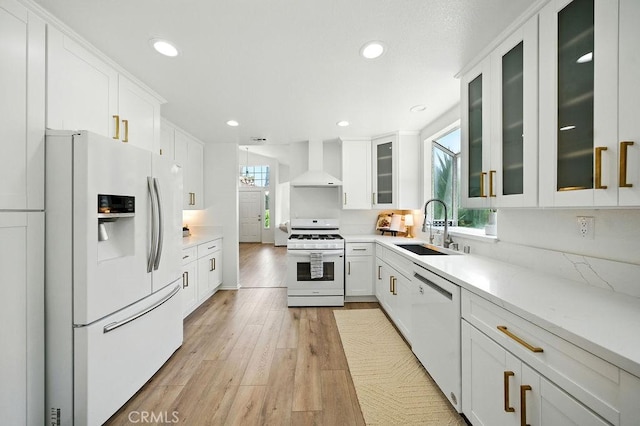 24322 Via Las Junitas, Murrieta, CA 92562 - kitchen with white appliances, wall chimney exhaust hood, white cabinetry, light wood-type flooring, and recessed lighting