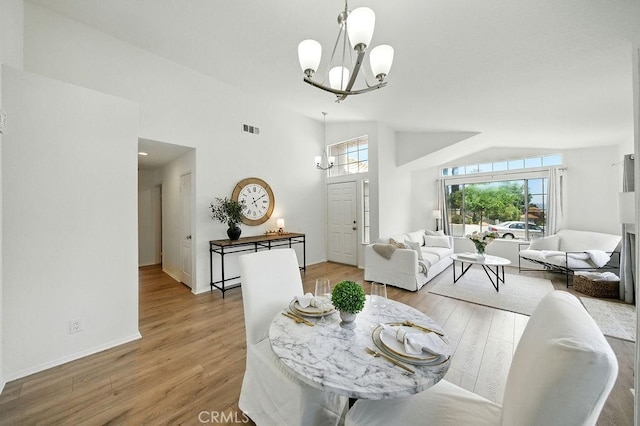 24322 Via Las Junitas, Murrieta, CA 92562 - dining space with a chandelier, wood finished floors, and lofted ceiling