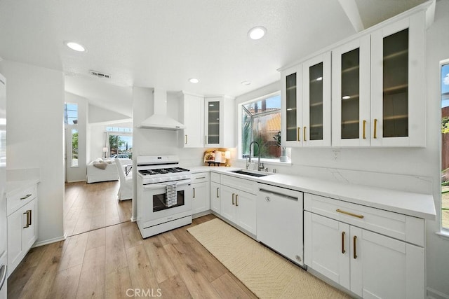24322 Via Las Junitas, Murrieta, CA 92562 - kitchen featuring white appliances, wall chimney range hood, healthy amount of natural light, light countertops, and recessed lighting