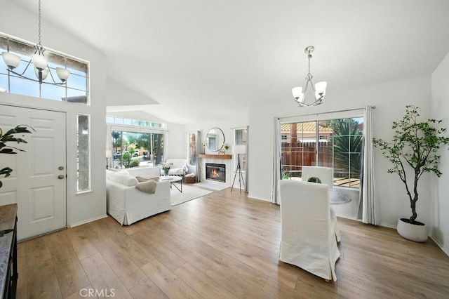 24322 Via Las Junitas, Murrieta, CA 92562 - living area with a chandelier, light wood-style floors, a fireplace, and lofted ceiling