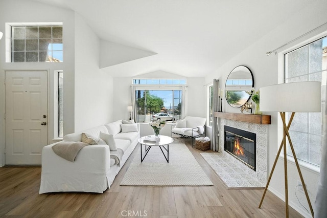 24322 Via Las Junitas, Murrieta, CA 92562 - living room with lofted ceiling, wood finished floors, and a tiled fireplace